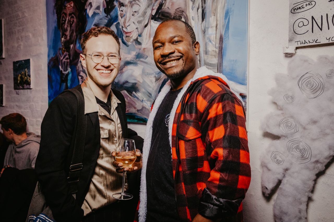 Sample stock photo of two people at an art gathering, not a Nelson & Associates event