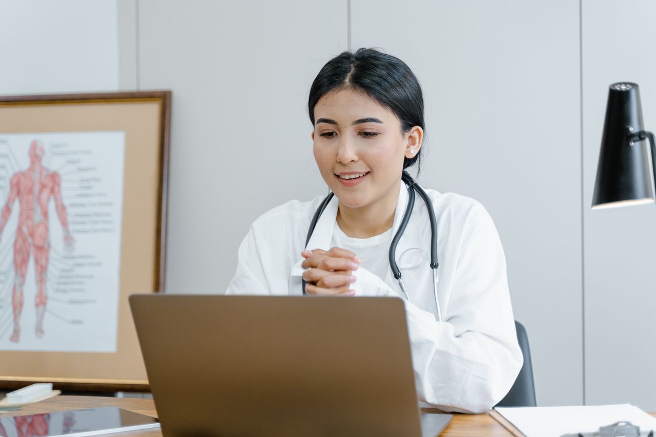 Sample stock photo of a person on a video call at a laptop, not Nelson & Associates staff